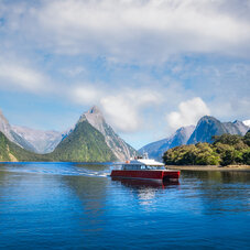 A local boat at Freshwater Basin at Milford Sound in the morning, going towards Southern Discoveries Marina. Milford Sound is a fjord and the most beautiful natural feature of New Zealand South Island